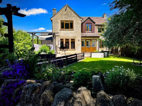 Front elevation of house and front garden. Accessed via the carpark.