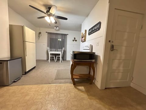 Kitchen with door to basement with laundry.