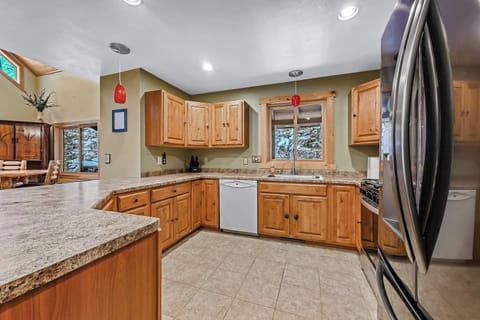 The kitchen features ample storage for your groceries and place settings for up to 8 people for dining.