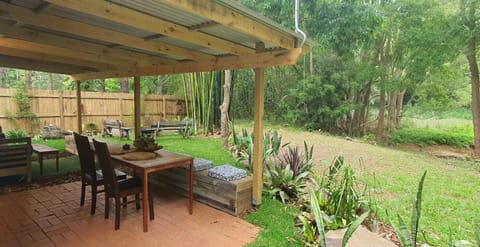  undercover outdoor dinning and sitting area viewing the garden and the creek 