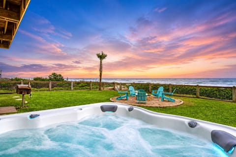 Beachfront hot tub with stunning sunset views, private oceanfront deck, and relaxing outdoor seating at Holiday, Bolivar Peninsula, TX vacation rental.