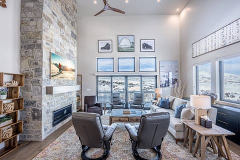 Featuring a large natural rock fireplace, 65" Samsung The Frame Smart TV and comfortable furnishings. It's the perfect place to gather and enjoy a mov