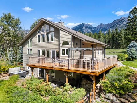 Backyard with a wrap-around deck, private hot tub, tons of outdoor seating, a fenced area for kids & pets to roam, a fire pit area and so much more to explore.