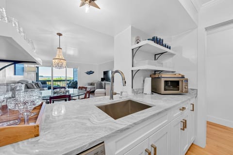 The kitchen pass through lets you look out to the great room and the ocean beyond the sliders!