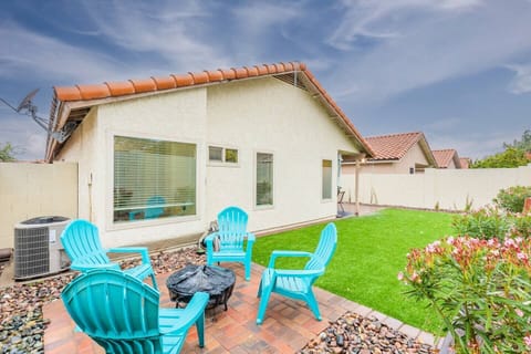 Unwind in a cozy backyard with fire pit (roasting sticks provided), comfortable seating, and a lush green lawn.