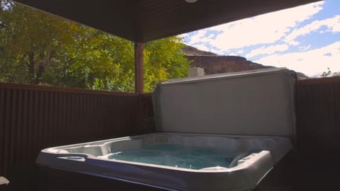 Tucked away on the private patio this hot tub is private with some views of the surrounding lava bluffs