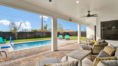 Outdoor seating with view of private pool and sun loungers