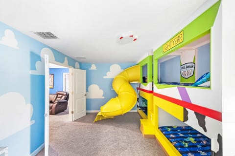 Experience the ultimate adventure in this Buzz Lightyear-themed room with bunk beds and a slide, perfect for young space rangers!