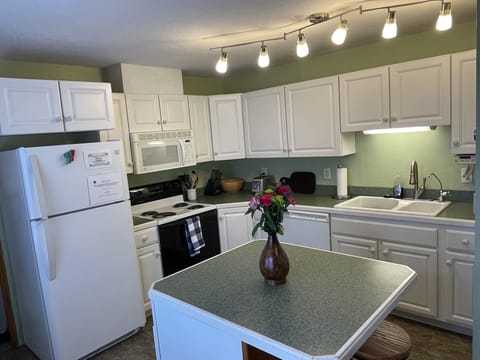 Come cook in our fully stocked kitchen with functional barstools at the island