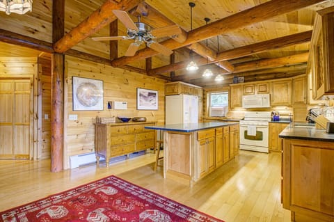 Cook up memories in our log cabin kitchen, featuring a spacious island with a countertop—a perfect blend of rustic and modern.