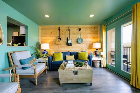 Transport yourself to a tropical paradise right in your own living room with these lush green walls and ocean-inspired blue furniture. It's like a vacation at home! 🏝️🌊 #StaycationVibes