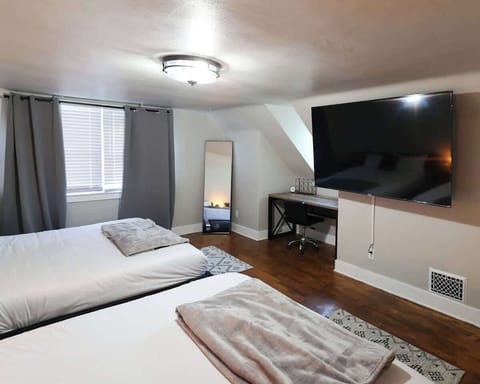 Bedroom #4 located on the Second Floor
75" Roku smart Tv
Workspace equipped with lamp and multiple power sources
Black out curtains