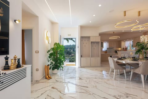 This space features a living room, indoor dining area, and kitchen