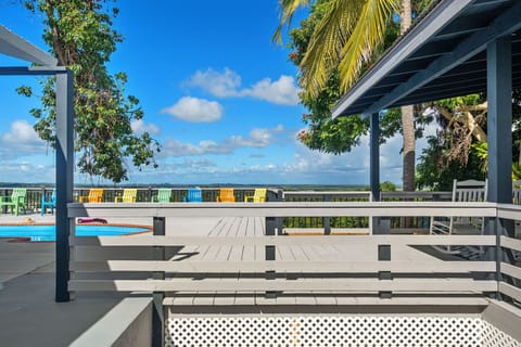 Spacious deck with pool and chairs overlooking  spectacular panoramic views