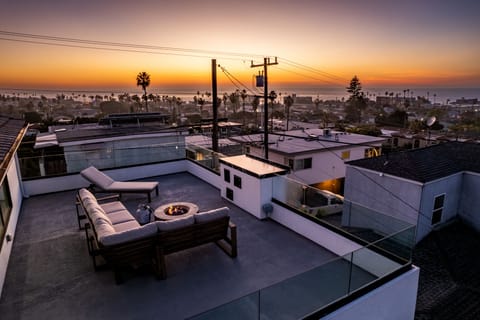 Rooftop patio with fire pit and lounge seating where you can enjoy the sunset!