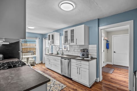 Kitchen & dining area with view to entryway and private attached garage.