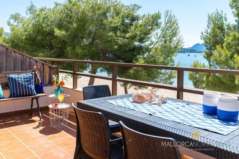 Furnished terrace with sea views in Puerto de Pollensa, Mallorca, perfect for outdoor dining and relaxation.