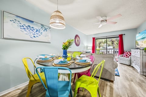 Gather around this vibrant dining space with seating for everyone, colorful accents, and a cozy view of the living area. Perfect for family meals! 🍴🌟
