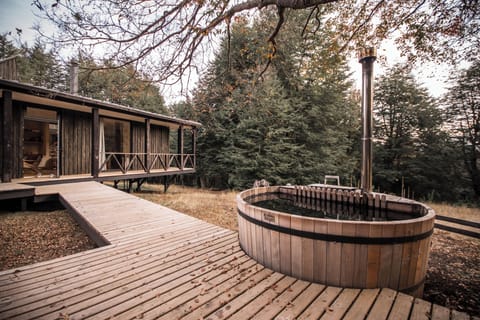 Hause and hot tub sorrounded by native forest