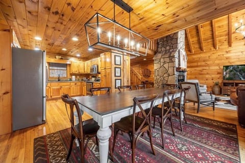 A large stylish wooden table sits at the center, offering plenty of seating for family meals, gatherings, or casual dining.