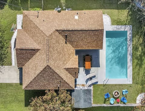 Aerial view of our home, backyard and blue swimming pool 