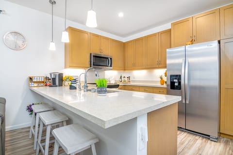 Chef-ready layout with stainless appliances and sleek wood cabinetry!