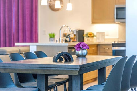 Sleek dining space with a modern table, soft lighting, and floral accents!