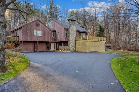 Welcome to Tee Time Retreat: charming wood exterior, stone chimney, garage, and wraparound deck