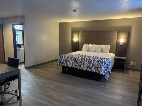 Suite, 1 King Bed, Non Smoking | Desk, laptop workspace, blackout drapes, iron/ironing board