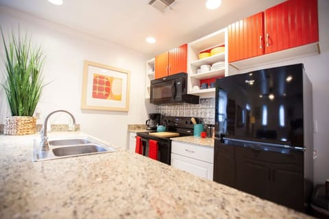 Fully functioning kitchen with a stove/oven, fridge, microwave and dishwasher.