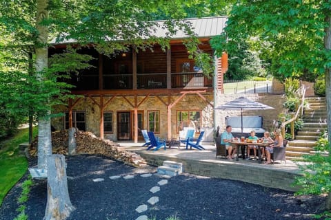 Relax in a tranquil backyard patio with firepit, 4 Adirondack chairs, one chair pod, umbrella, dining table for six, lazy hammock and hot tub.