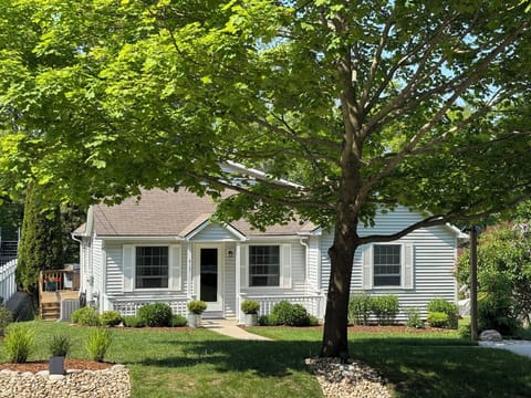 EXTERIOR:  The front of the house in summer.