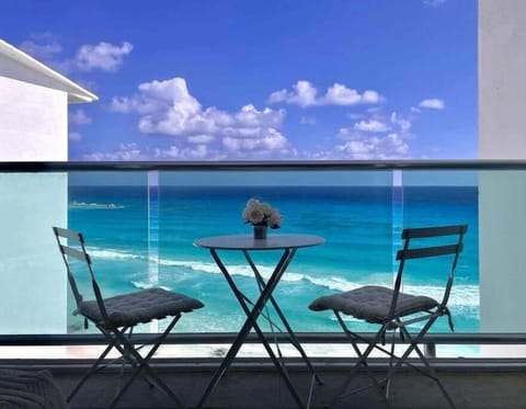 Private balcony with table and chairs overlooking the Caribbean Sea