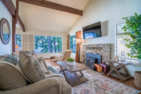 With exposed wooden beams and a cozy stone fireplace, the living room is one of the most beloved areas in the fairland cottage