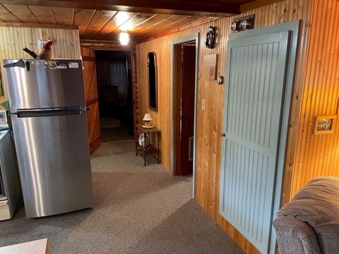 Hallway leading to the bathroom and both bedrooms. Note the full-size fridge!