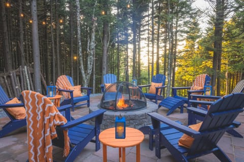 Vibrant firepit area with a canopy of string lights: roast smores on the fire!