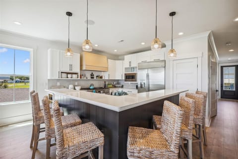 The kitchen island provides additional counter space for serving snacks or meals