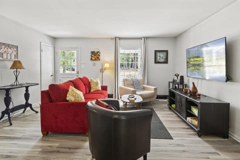 comfortable living room with a huge TV on the wall