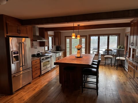 Kitchen with large island that views to back yard and pond.
