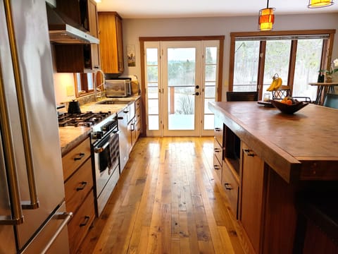 Kitchen view onto the deck and overlooking the pond and river