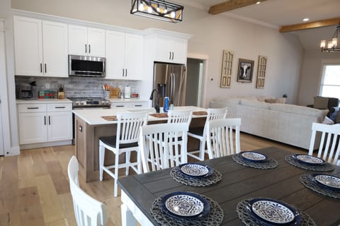 Kitchen and dining area. Seats 6 at table and 3 at the counter.
