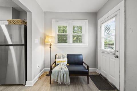 Our beautifully designed living room, featuring a comfy chair and stylish lamp for the perfect unwind spot. 🛋️💡