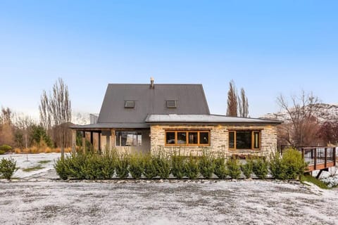 View of the main house during a crisp winter day, surrounded by snow. 