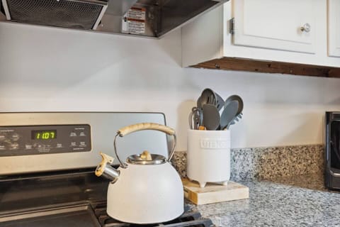 Tea kettle and cooking utensils are at your fingertips.