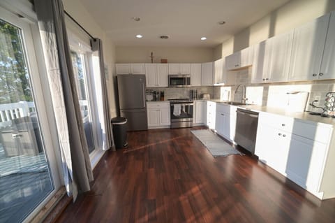 Light and airy, this kitchen is a breath of fresh air. The white cabinets and wood floors reflect the natural light, making the space feel even larger.