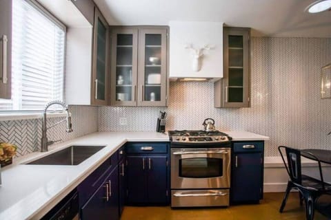 Modern kitchen with open shelving and everything you need to cook at home.