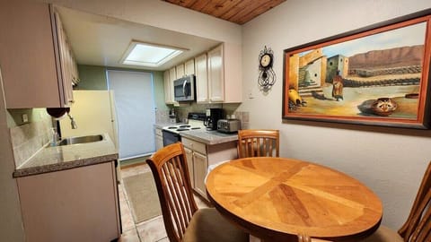 The dining area is conveniently located just off the kitchen where you will find a table with seating for four. In the kitchen you will find all the basic cookware and appliances needed to prepare a meal.
