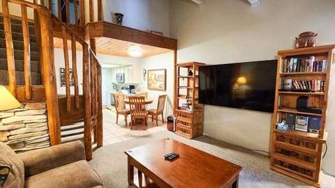 The view over the main living space showcases the open layout living, dining, and kitchen area making it easy to stay connected with your group while in the condo.