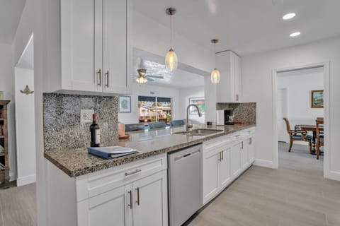 In the Kitchen looking out through the Florida room to the pool and canal.