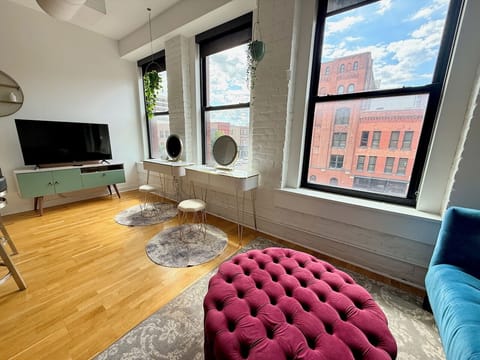 Living room space with two vanities and lit mirrors for getting ready.